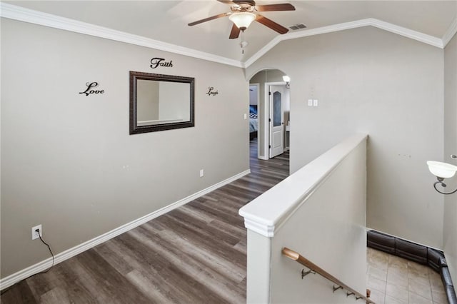 stairway featuring hardwood / wood-style flooring, ornamental molding, lofted ceiling, and ceiling fan