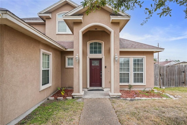 view of exterior entry featuring a yard