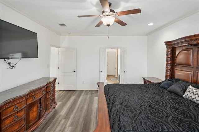 bedroom with crown molding, ceiling fan, and hardwood / wood-style flooring