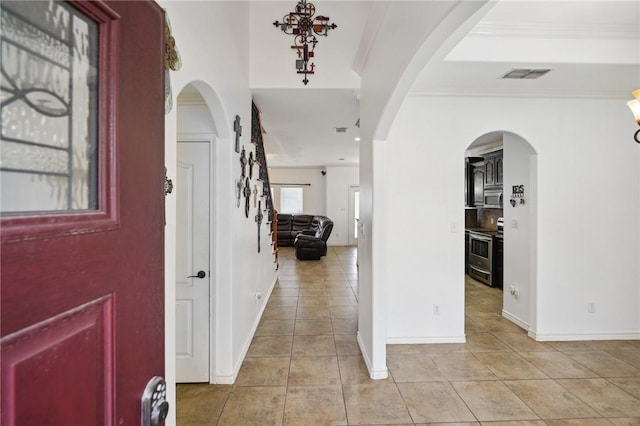 tiled entryway featuring ornamental molding