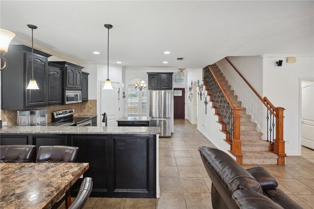 kitchen with pendant lighting, stainless steel appliances, tasteful backsplash, ornamental molding, and kitchen peninsula