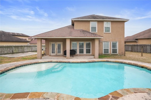 view of pool with a patio, grilling area, and french doors