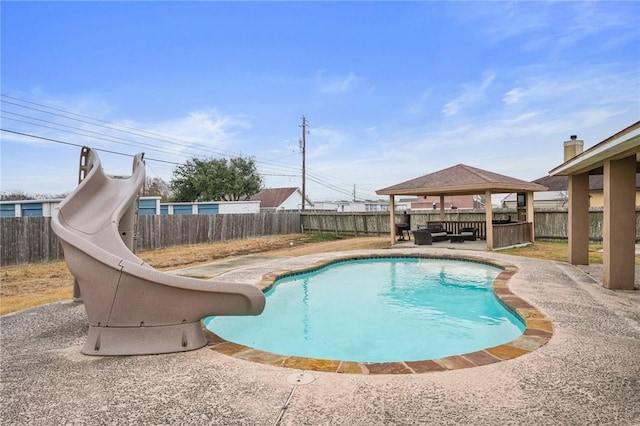 view of swimming pool with a gazebo, a patio area, and a water slide