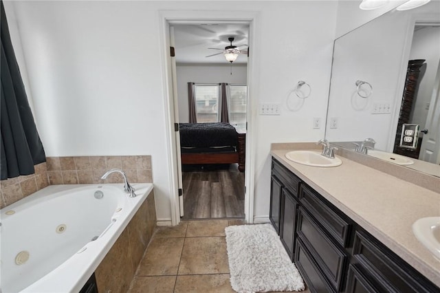 bathroom with vanity, tile patterned floors, tiled bath, and ceiling fan