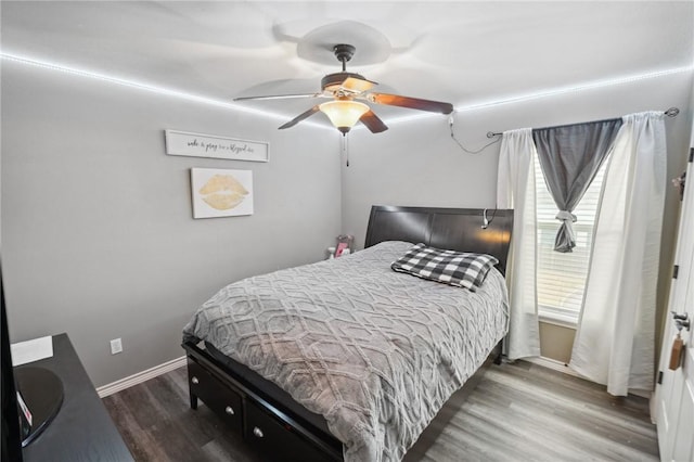 bedroom featuring dark wood-type flooring and ceiling fan