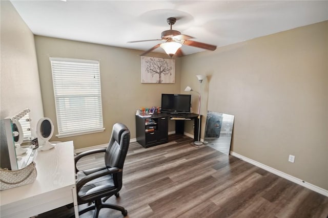 home office featuring dark wood-type flooring and ceiling fan