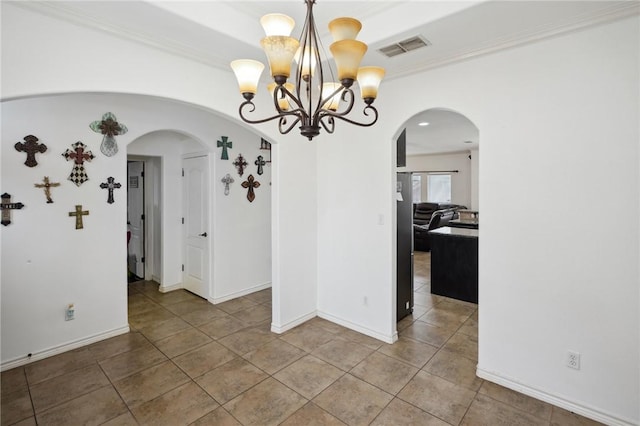 unfurnished dining area with tile patterned flooring and ornamental molding