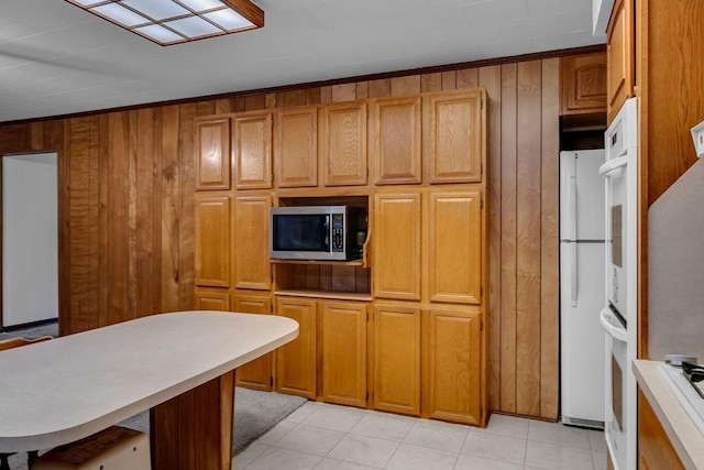 10630 Rockwood, Corpus Christi, TX 78410 - kitchen with white appliances, light countertops, brown cabinets, and wooden walls
