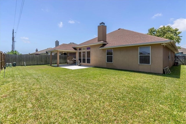 2618 Gentle Wind Ave, Corpus Christi, TX 78414 - back of property featuring a fenced backyard, a patio area, a chimney, stucco siding, and roof with shingles