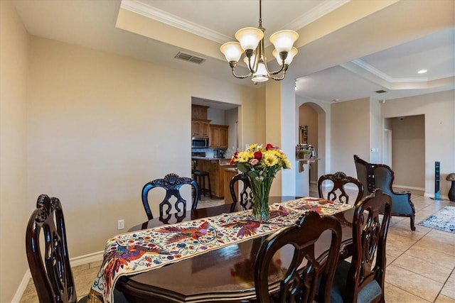 2618 Gentle Wind Ave, Corpus Christi, TX 78414 - dining room featuring a tray ceiling, arched walkways, a chandelier, crown molding, and light tile patterned flooring