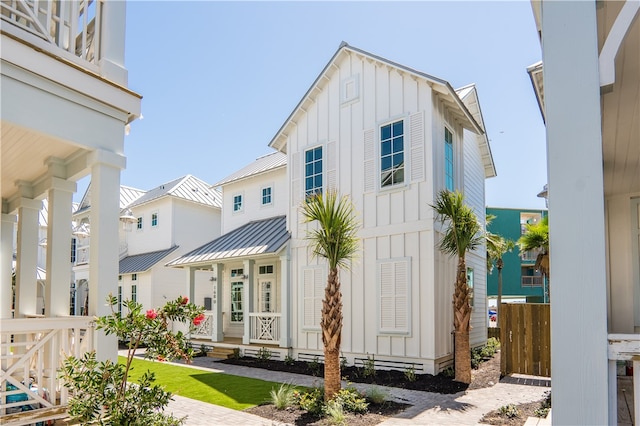 exterior space with a standing seam roof, metal roof, and board and batten siding