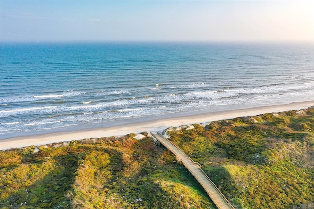 drone / aerial view featuring a water view and a view of the beach