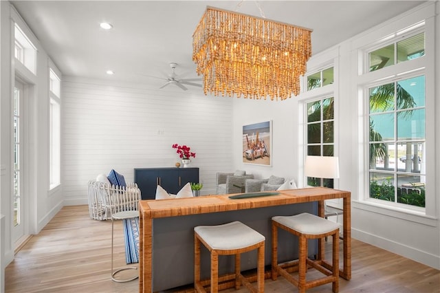 interior space featuring baseboards, light wood-type flooring, and recessed lighting