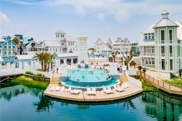 pool featuring a residential view and a water view