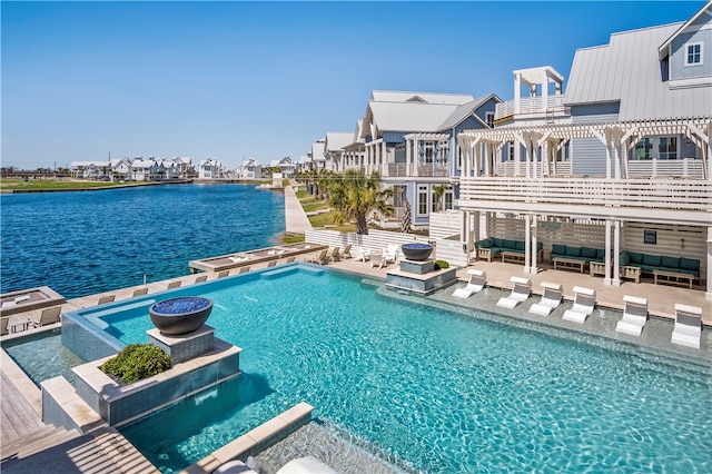 outdoor pool featuring a water view, an outdoor hangout area, a patio area, a pergola, and a jacuzzi