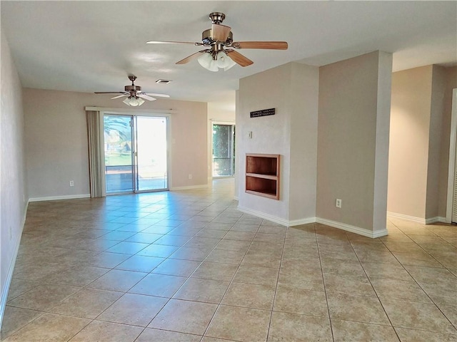 unfurnished living room featuring a ceiling fan, light tile patterned floors, baseboards, and visible vents