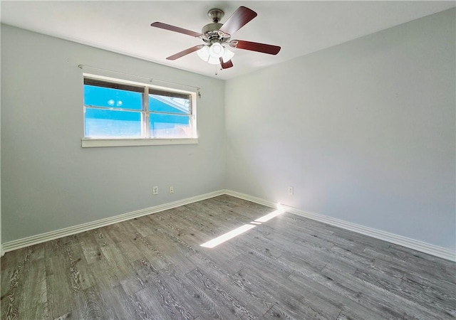 unfurnished room featuring baseboards, ceiling fan, and wood finished floors