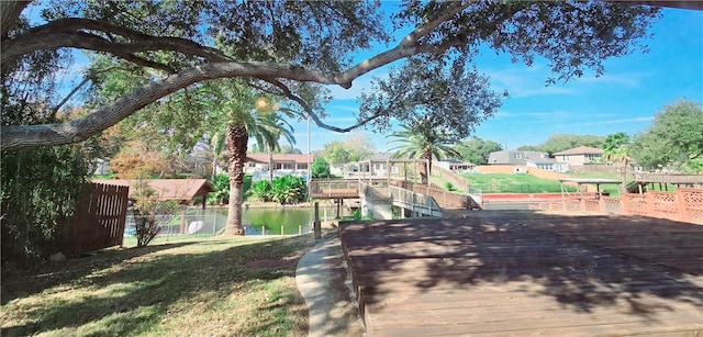exterior space featuring a residential view, a yard, and fence