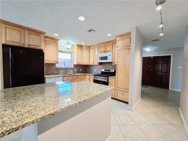 kitchen with white appliances, decorative backsplash, visible vents, light stone countertops, and light brown cabinets