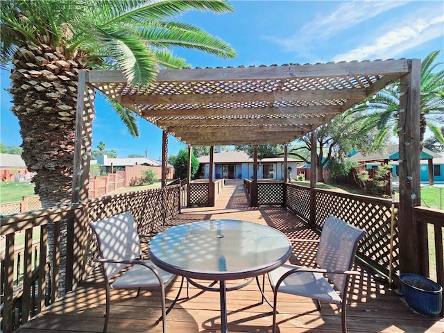 deck featuring a pergola and outdoor dining space