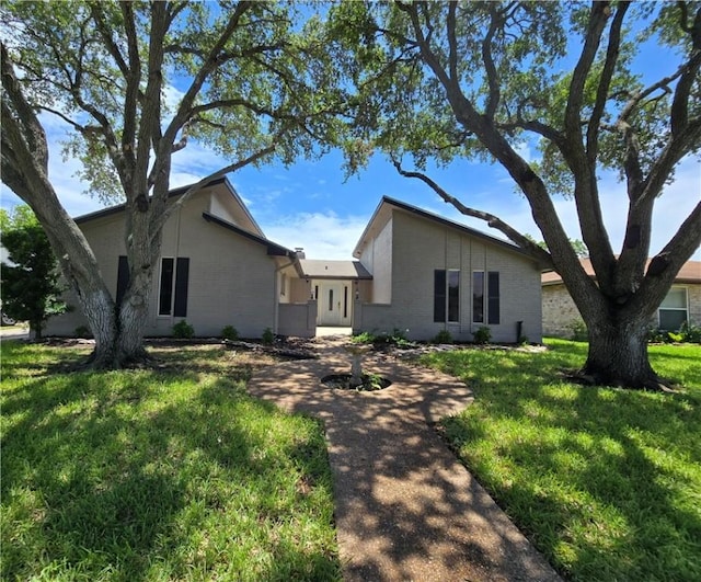 4109 Eagle Dr, Corpus Christi, TX 78413 - mid-century inspired home with a front lawn and brick siding