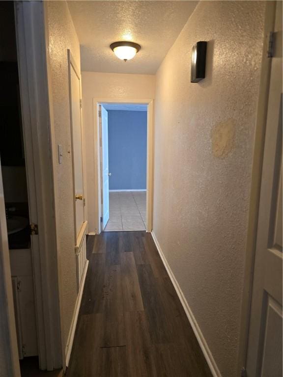 4109 Eagle Dr, Corpus Christi, TX 78413 - hall featuring a textured wall, a textured ceiling, and dark wood-style flooring