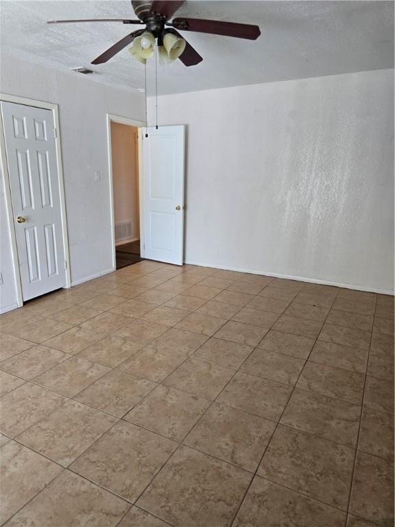 4109 Eagle Dr, Corpus Christi, TX 78413 - spare room featuring a ceiling fan and tile patterned flooring