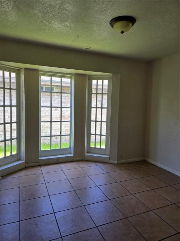 4109 Eagle Dr, Corpus Christi, TX 78413 - tiled spare room with a textured ceiling and healthy amount of natural light