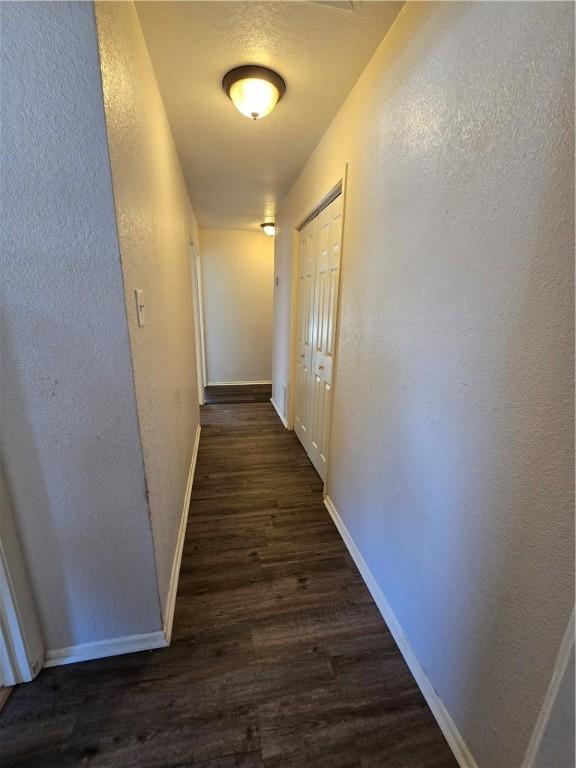 4109 Eagle Dr, Corpus Christi, TX 78413 - hallway featuring dark wood-style floors and a textured wall