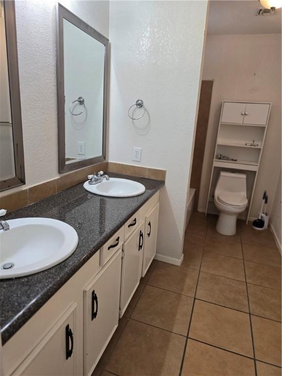 4109 Eagle Dr, Corpus Christi, TX 78413 - bathroom with double vanity and tile patterned flooring