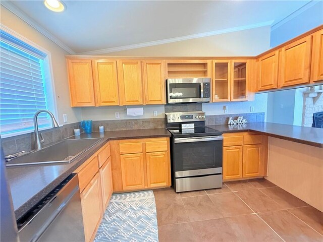 1182 Lee Rd, Aransas Pass, TX 78336 - kitchen featuring appliances with stainless steel finishes, a sink, ornamental molding, dark countertops, and light tile patterned floors