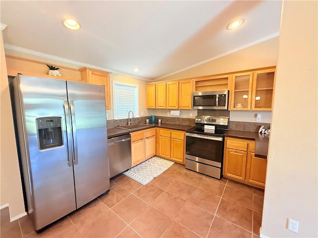 1182 Lee Rd, Aransas Pass, TX 78336 - kitchen featuring stainless steel appliances, crown molding, dark countertops, light brown cabinetry, and lofted ceiling