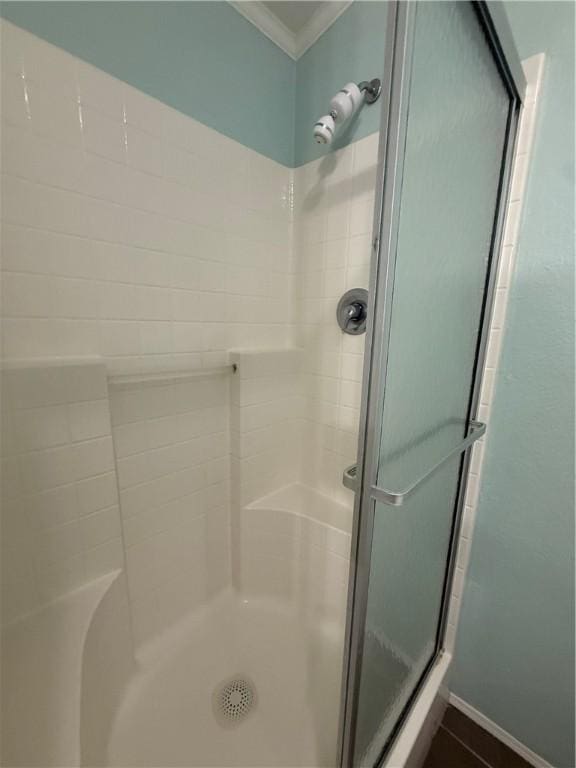 1182 Lee Rd, Aransas Pass, TX 78336 - full bathroom featuring a shower stall, crown molding, and baseboards