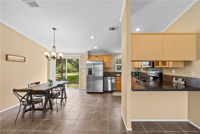 1182 Lee Rd, Aransas Pass, TX 78336 - kitchen featuring stainless steel appliances, a chandelier, light brown cabinets, dark countertops, and recessed lighting