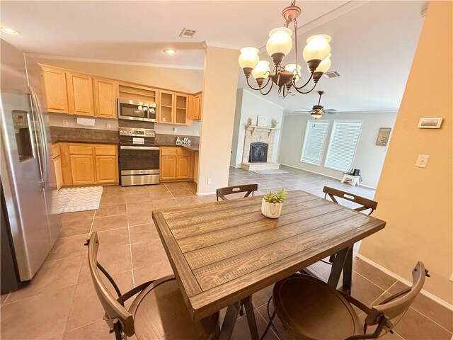 1182 Lee Rd, Aransas Pass, TX 78336 - dining room featuring ornamental molding, a chandelier, a ceiling fan, baseboards, and light tile patterned flooring