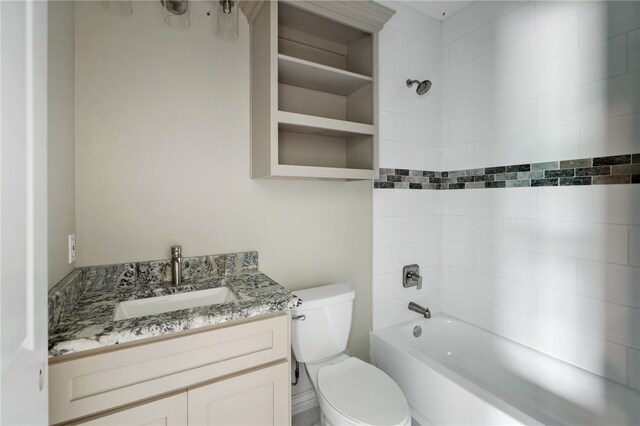 full bathroom with vanity, toilet, and tiled shower / bath