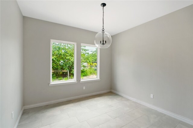 spare room featuring light tile patterned flooring