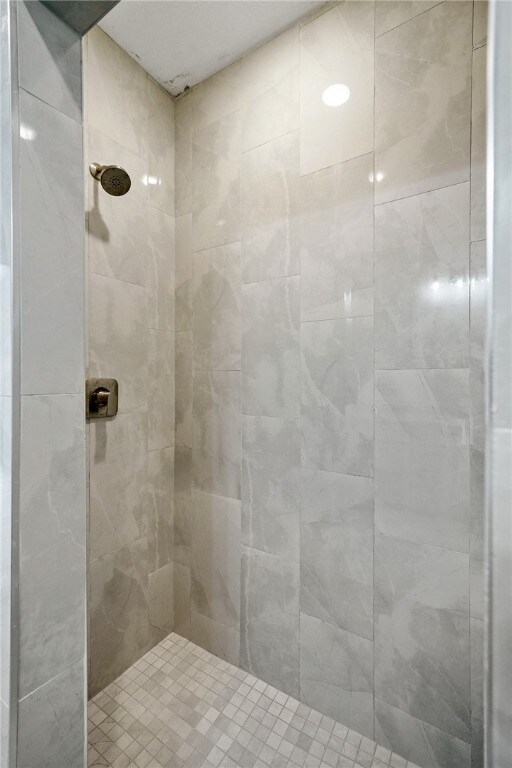 bathroom with tiled shower