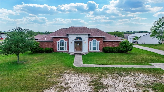 mediterranean / spanish-style home with a front lawn