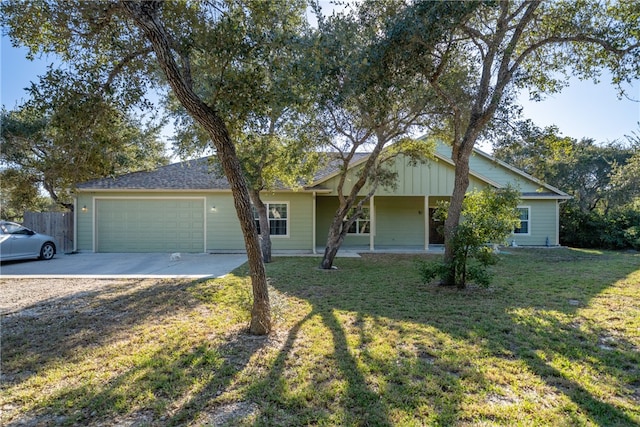 single story home featuring a front lawn, a porch, and a garage