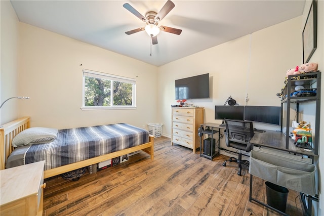 bedroom featuring radiator, hardwood / wood-style flooring, and ceiling fan