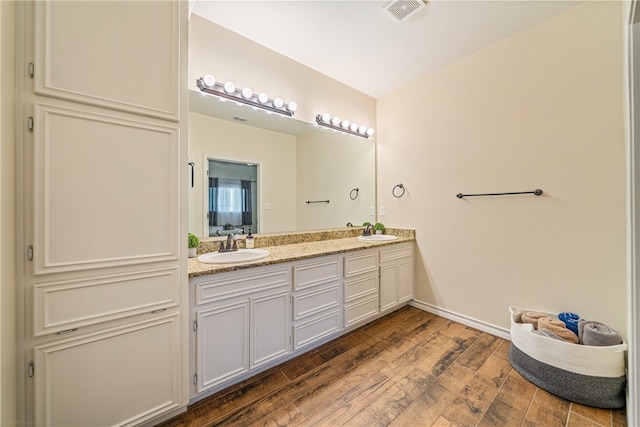 bathroom featuring vanity and wood-type flooring