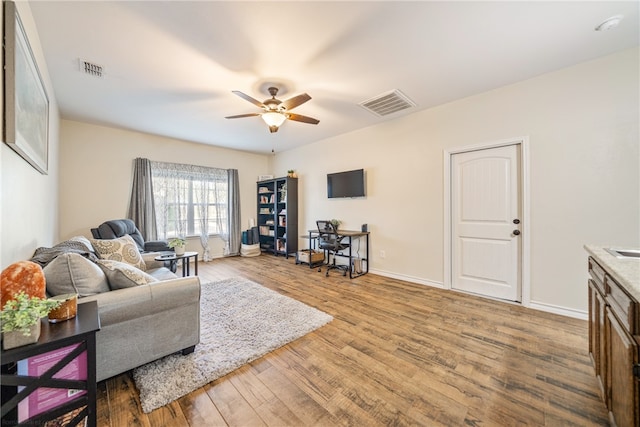 living room featuring ceiling fan and wood-type flooring