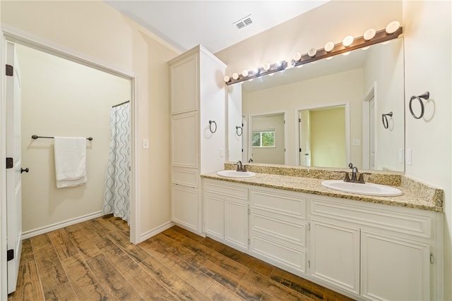 bathroom with a shower with curtain, vanity, and hardwood / wood-style flooring