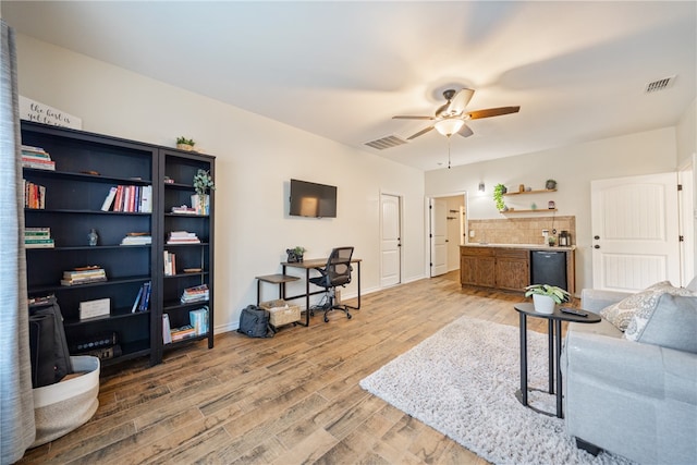 living room with ceiling fan and light hardwood / wood-style flooring