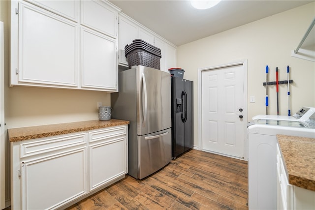 kitchen with white cabinetry, stainless steel fridge with ice dispenser, dark hardwood / wood-style flooring, stainless steel fridge, and washer and dryer