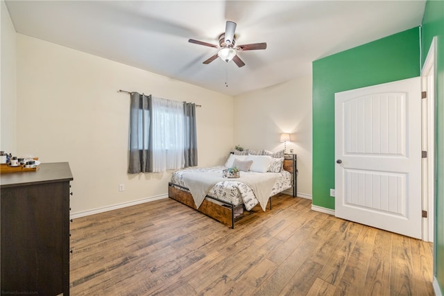 bedroom with hardwood / wood-style floors and ceiling fan