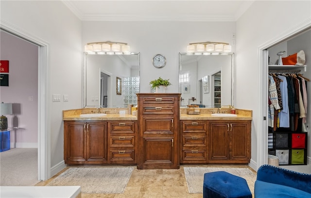 full bath featuring crown molding, double vanity, a spacious closet, and a sink