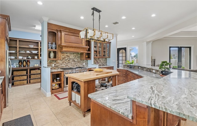 kitchen with ornate columns, open shelves, wood counters, and high end stove