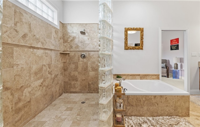 bathroom with walk in shower and a bath